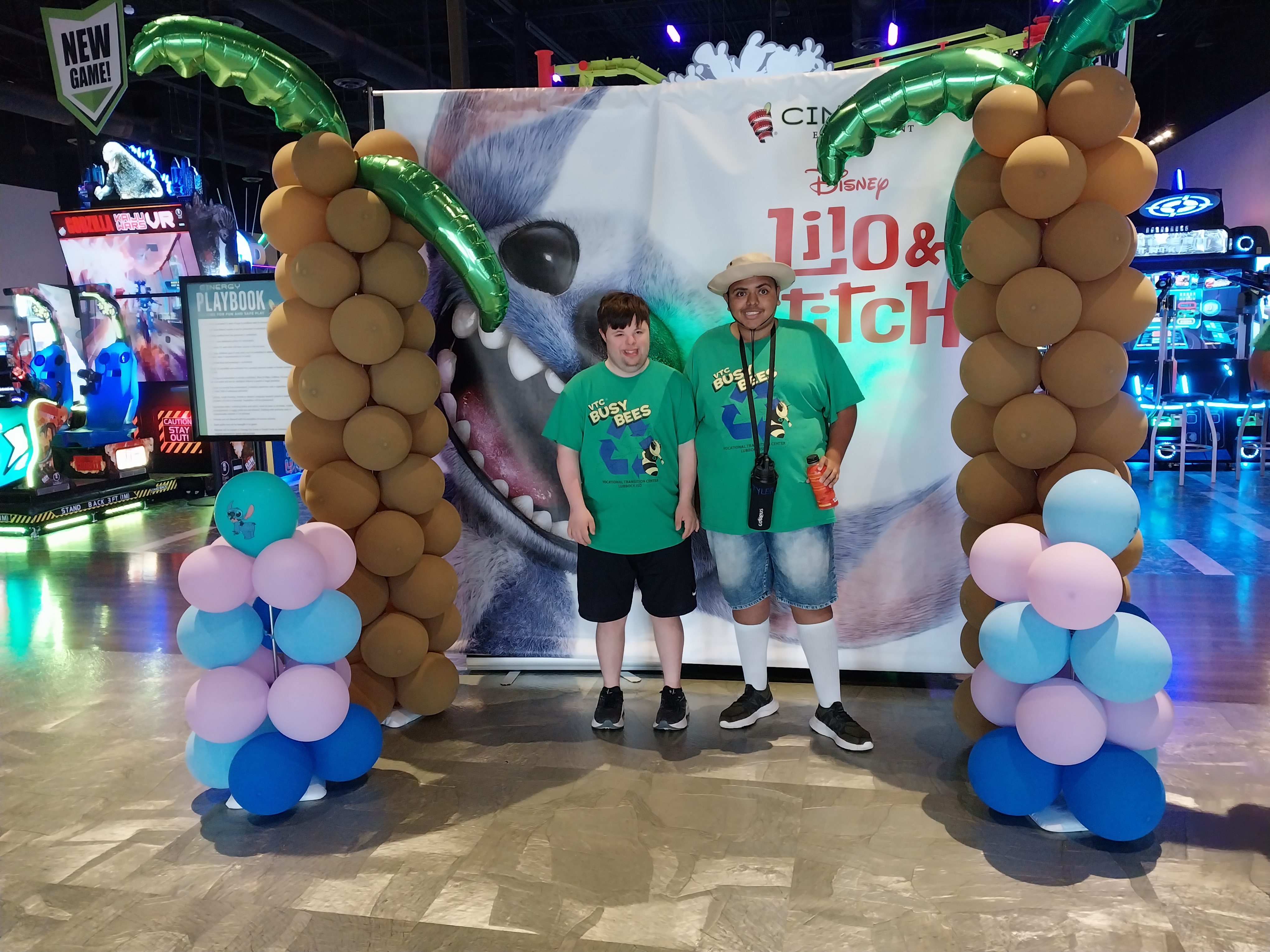 Brogan and Tyler posing in front of the Lilo and Stitch balloon arches