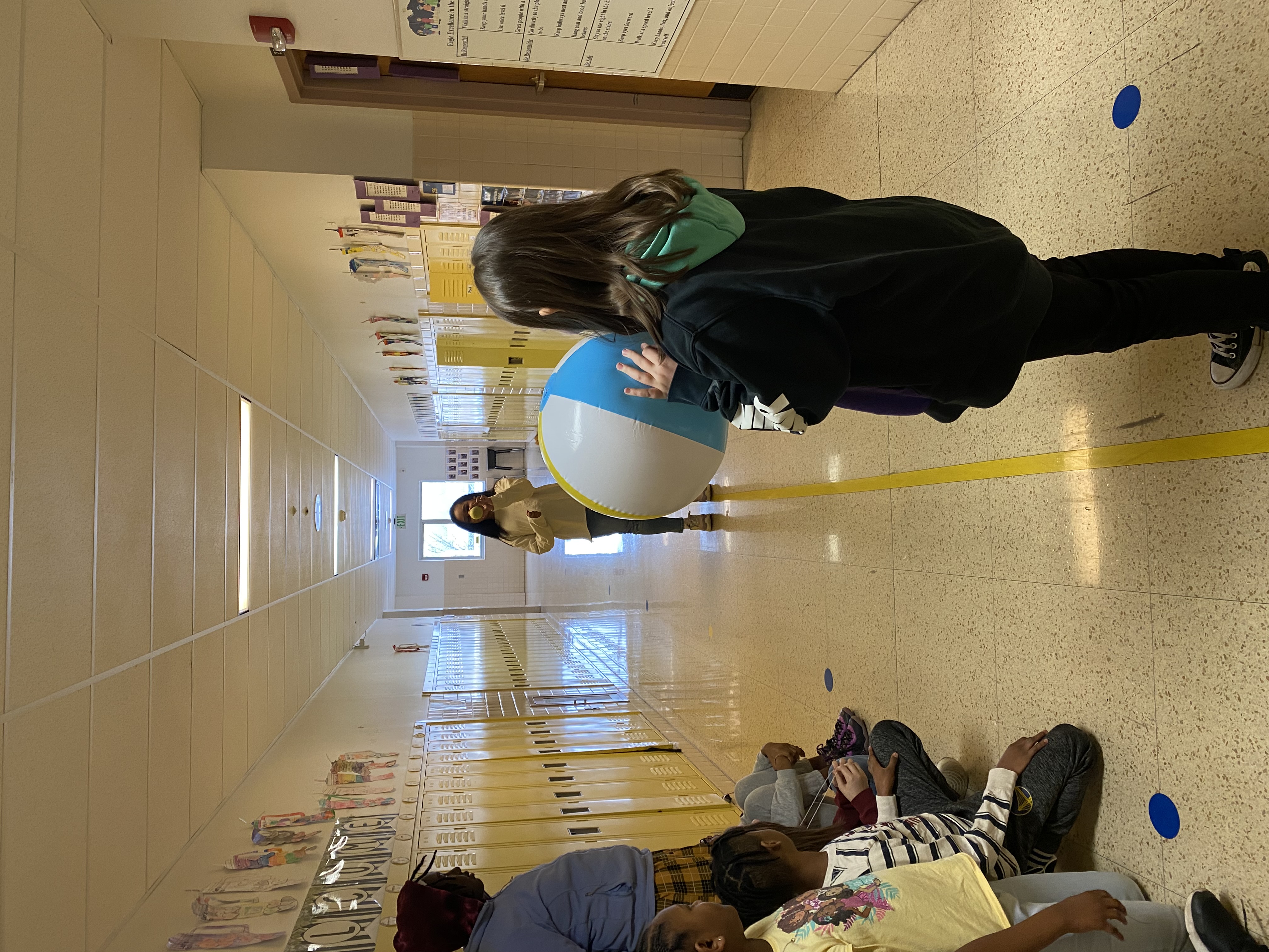 Students doing eclipse experiment in hallway