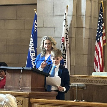 Lawson L. reading his "What my Mother Means to Me" Essay at the State Capital 