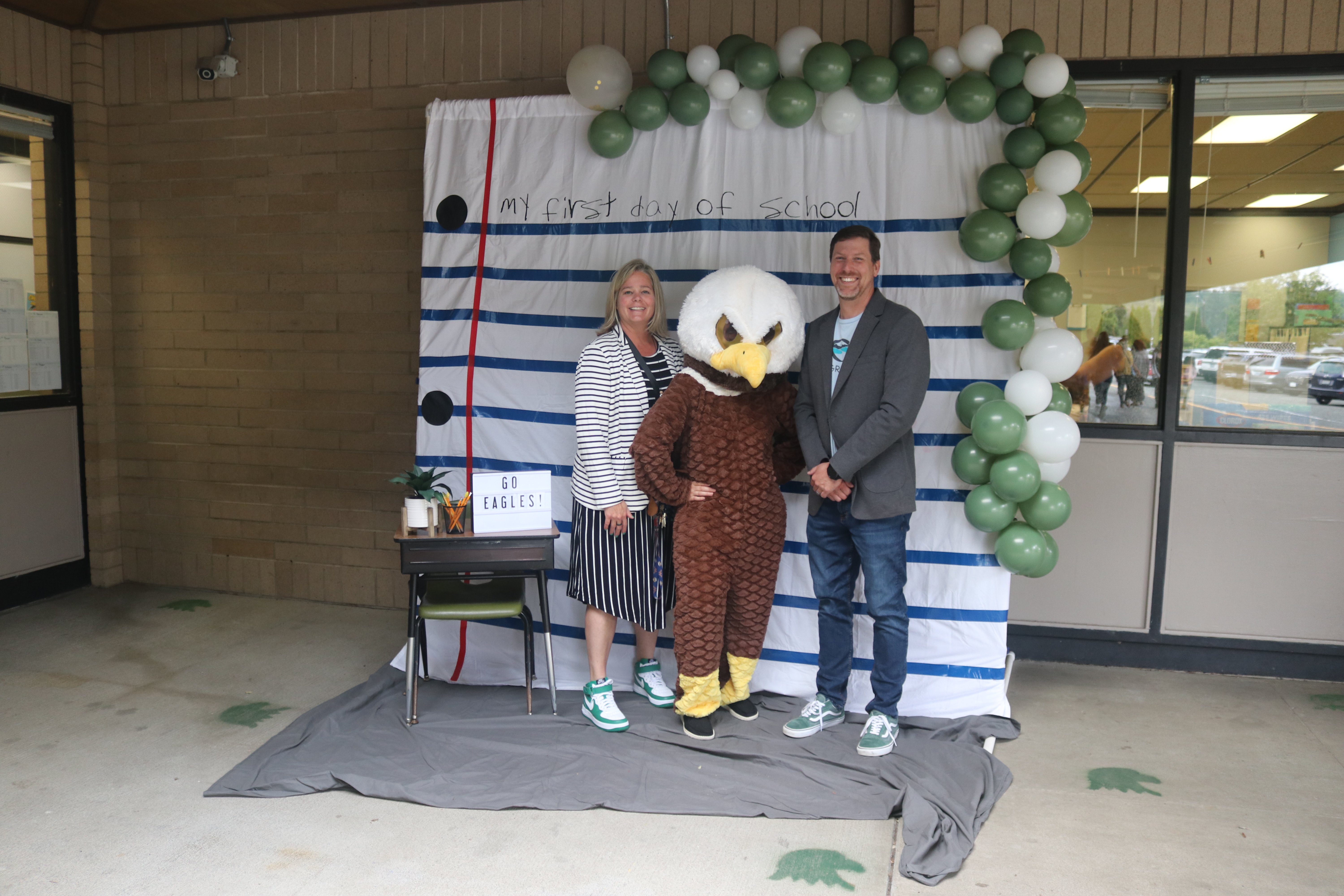 Principal Poppe and Assistant Principal Knowles stand with Stemmy the Eagle mascot on the first day of school! 