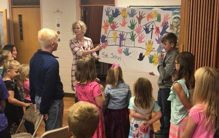 Teacher showing a board to students