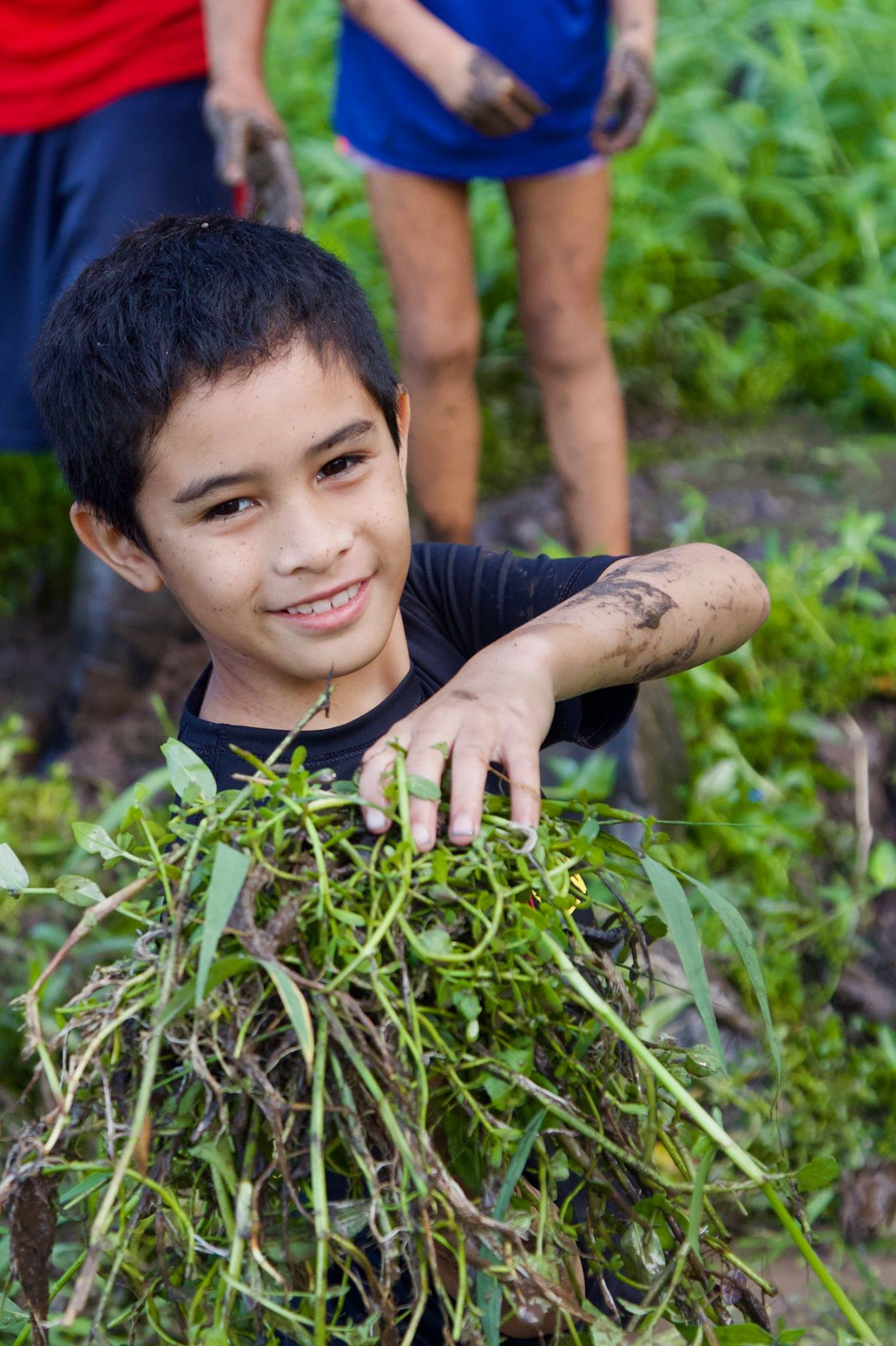 student holding bundle of plants