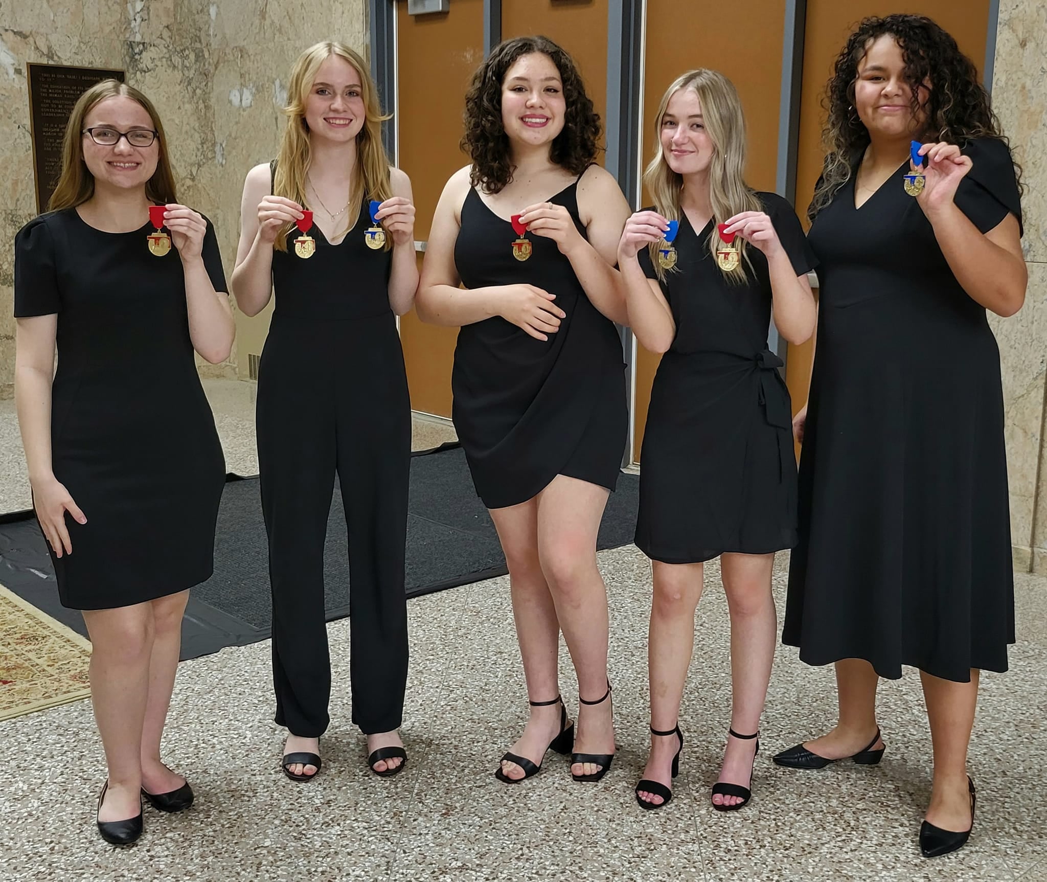 Choir students hold all state pins
