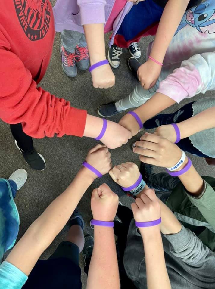 students display purple wristbands
