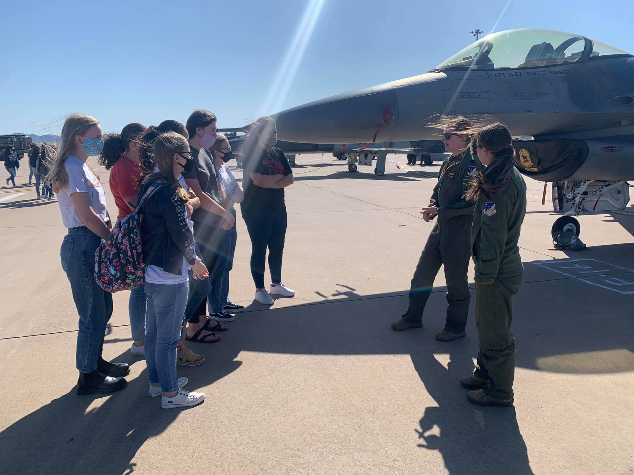STEM girls club tours Air Force Base with female officer