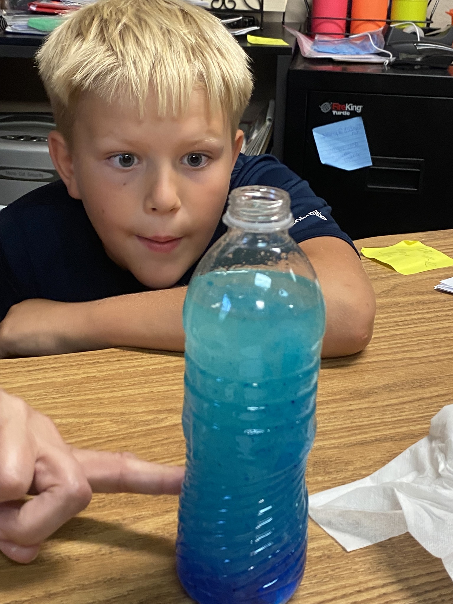 A student looks in amazement at his science experiment 