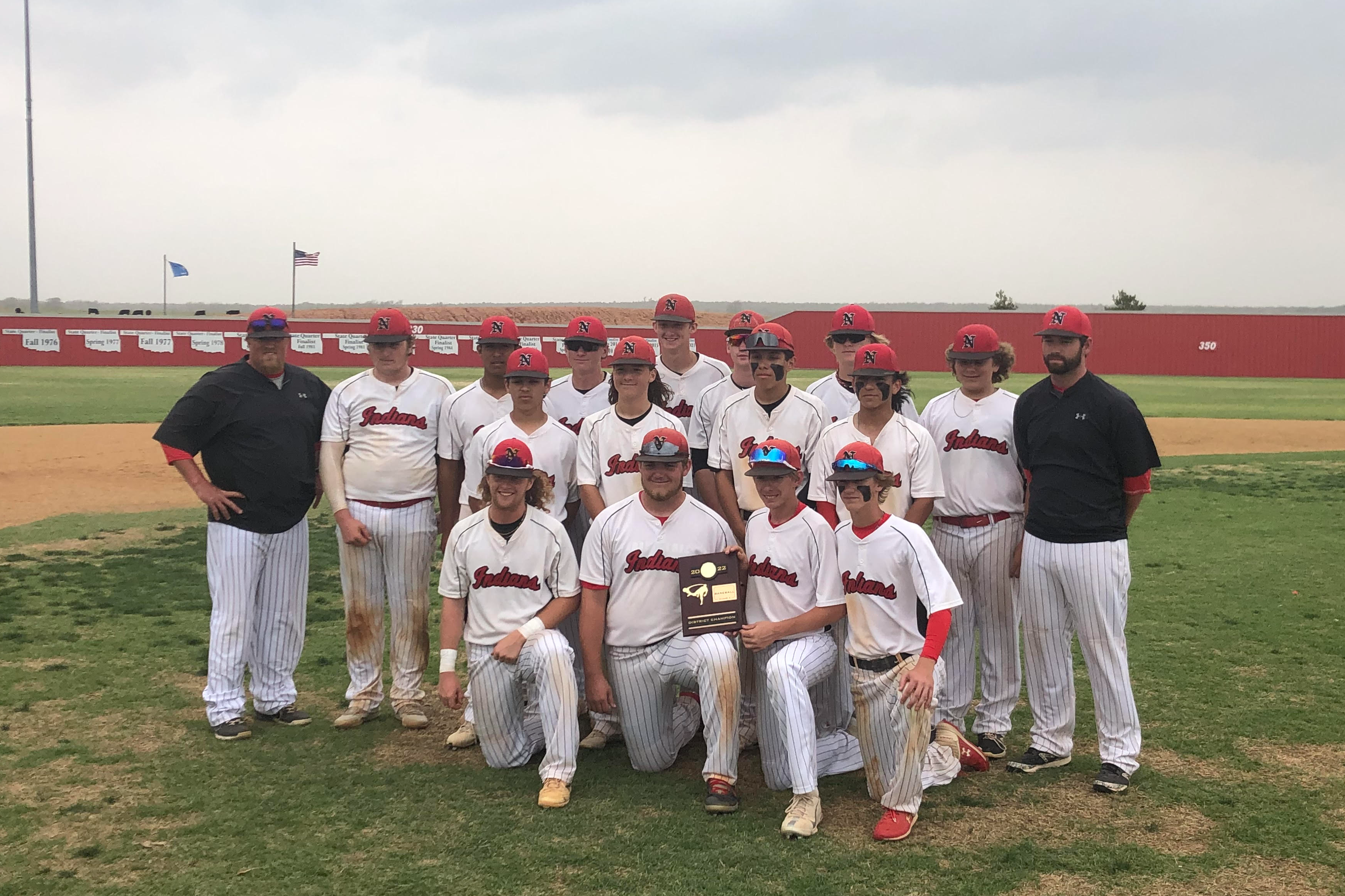 baseball team accepting the 2022 district champions plaque