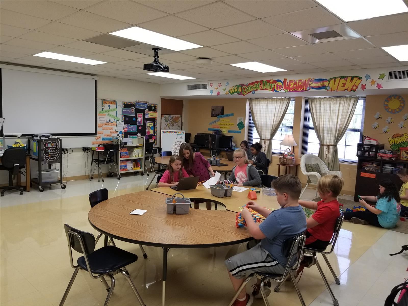 Students sitting at a around table in a classroom
