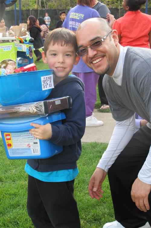 man smiling with his son during an evente