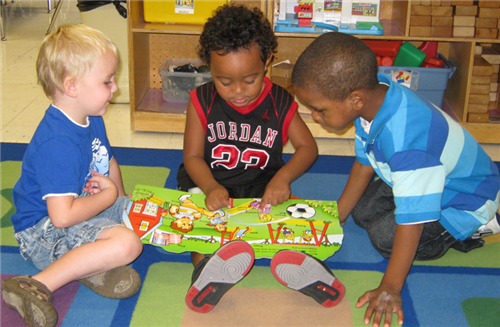 three students reading a book together