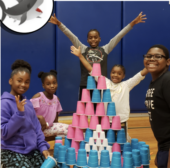 group of students celebrate a project with building blocks