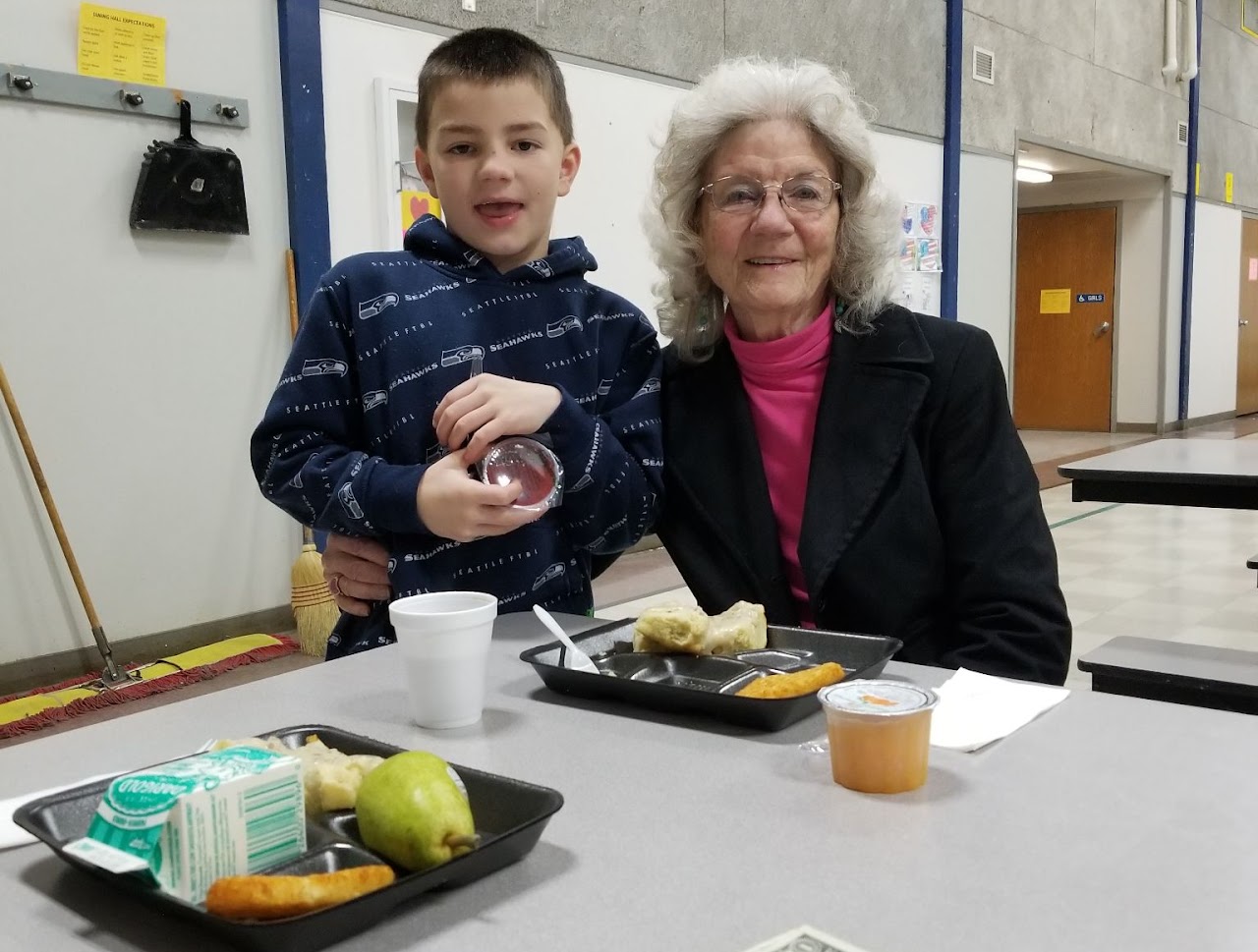 woman with grandson smiling at lunch table
