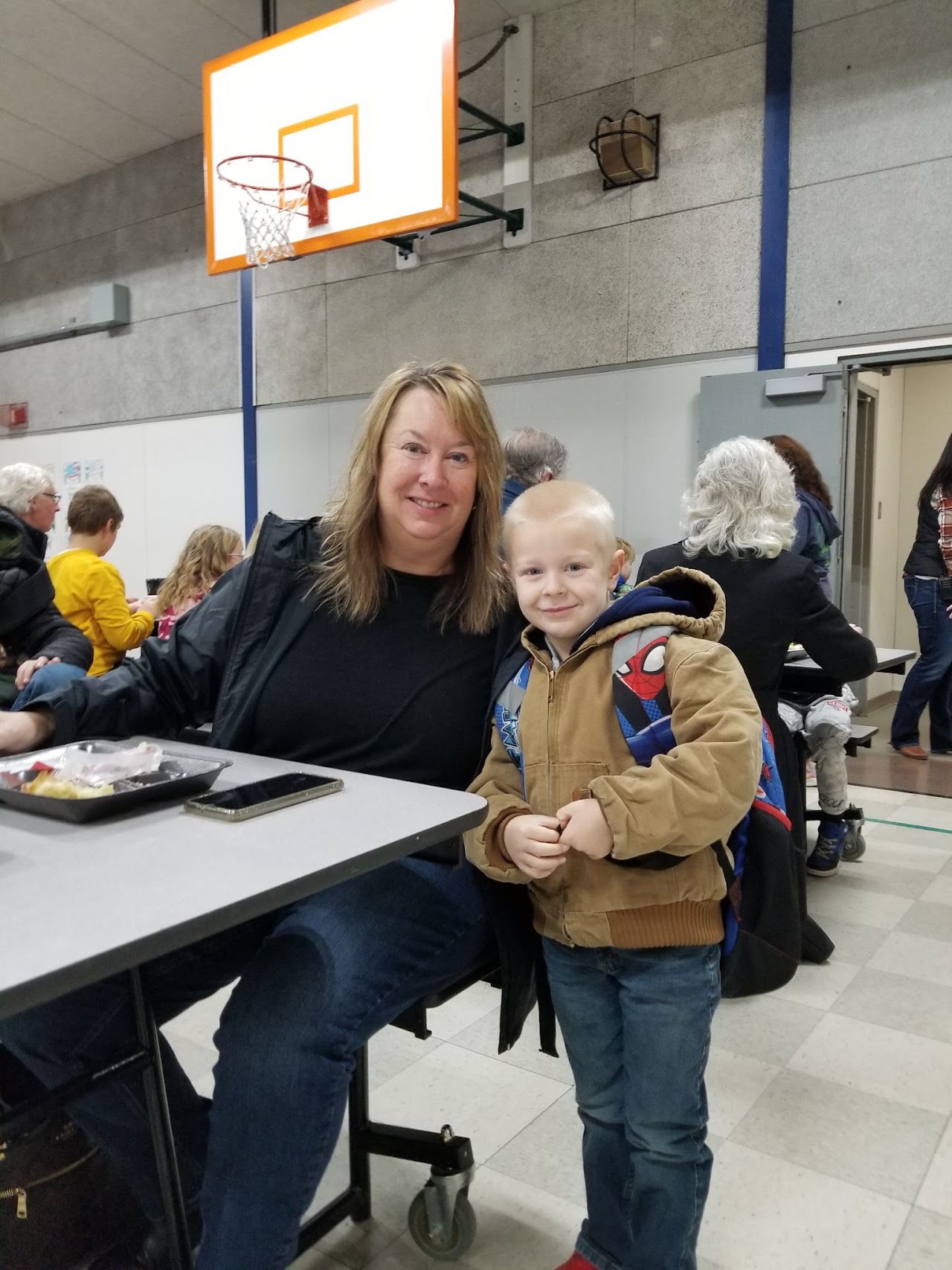 woman smiling with son at the lunch table