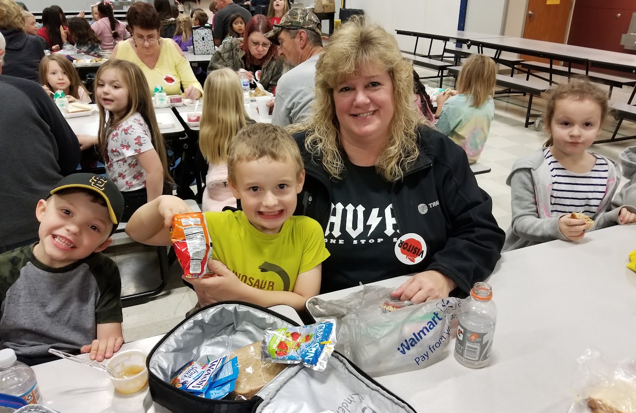 grandmother smiling with grandson at lunch