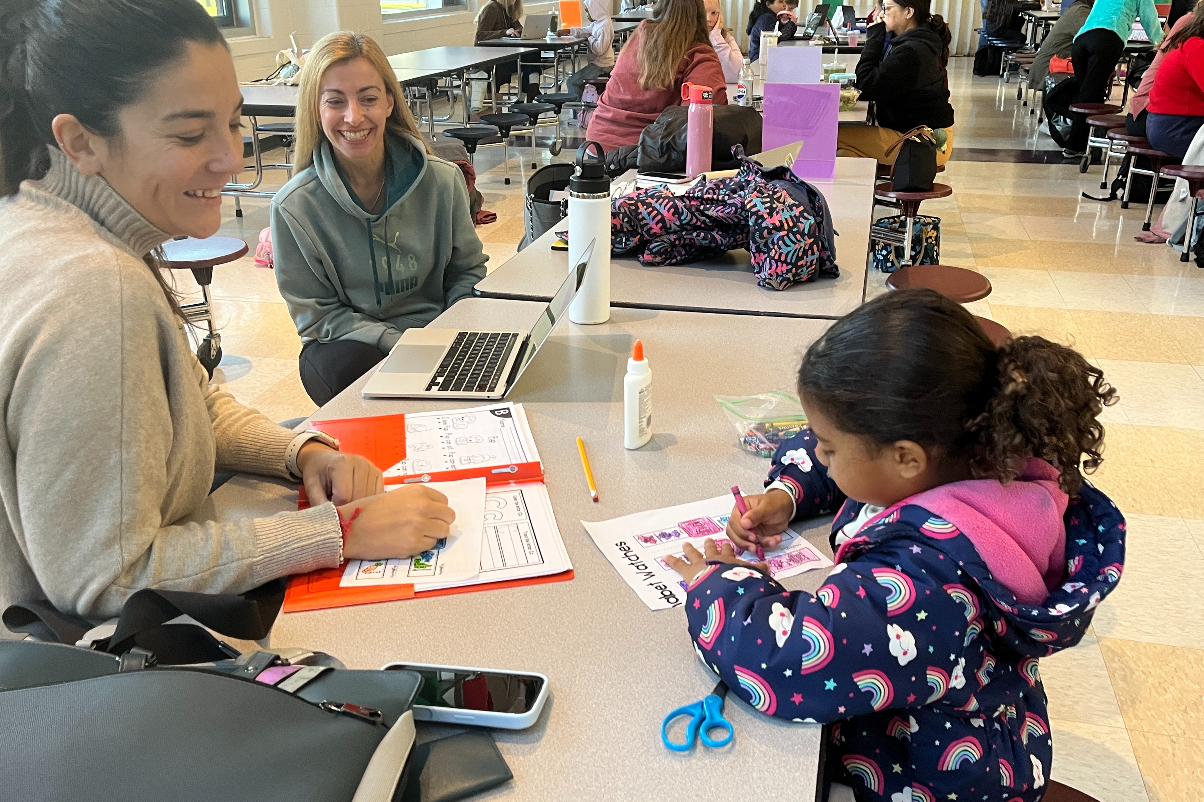 Student works on homework with teacher