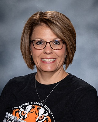 Michelle Peters - cropped light hair with glasses and dark blouse