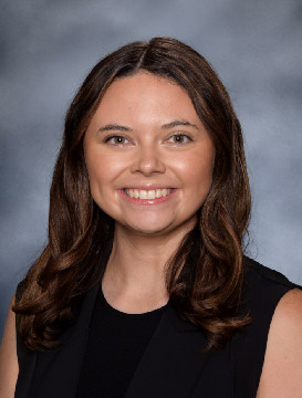 Female smiling with dark hair and black shirt