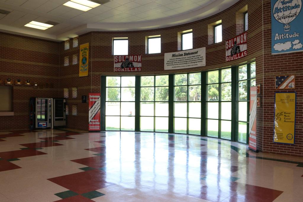 A photo of a school hallway with windows