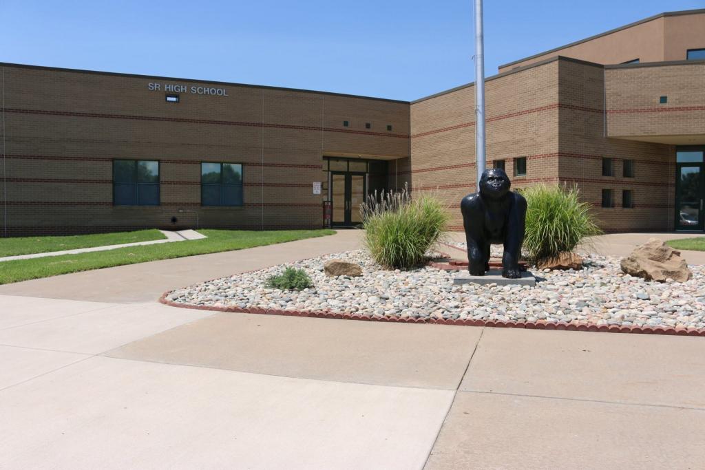 A photo of the front of the school and a statue of the gorilla school mascot