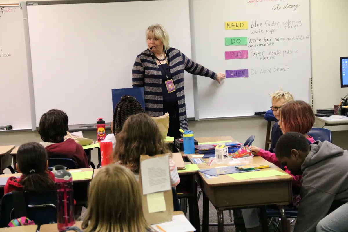 Teacher pointing to board