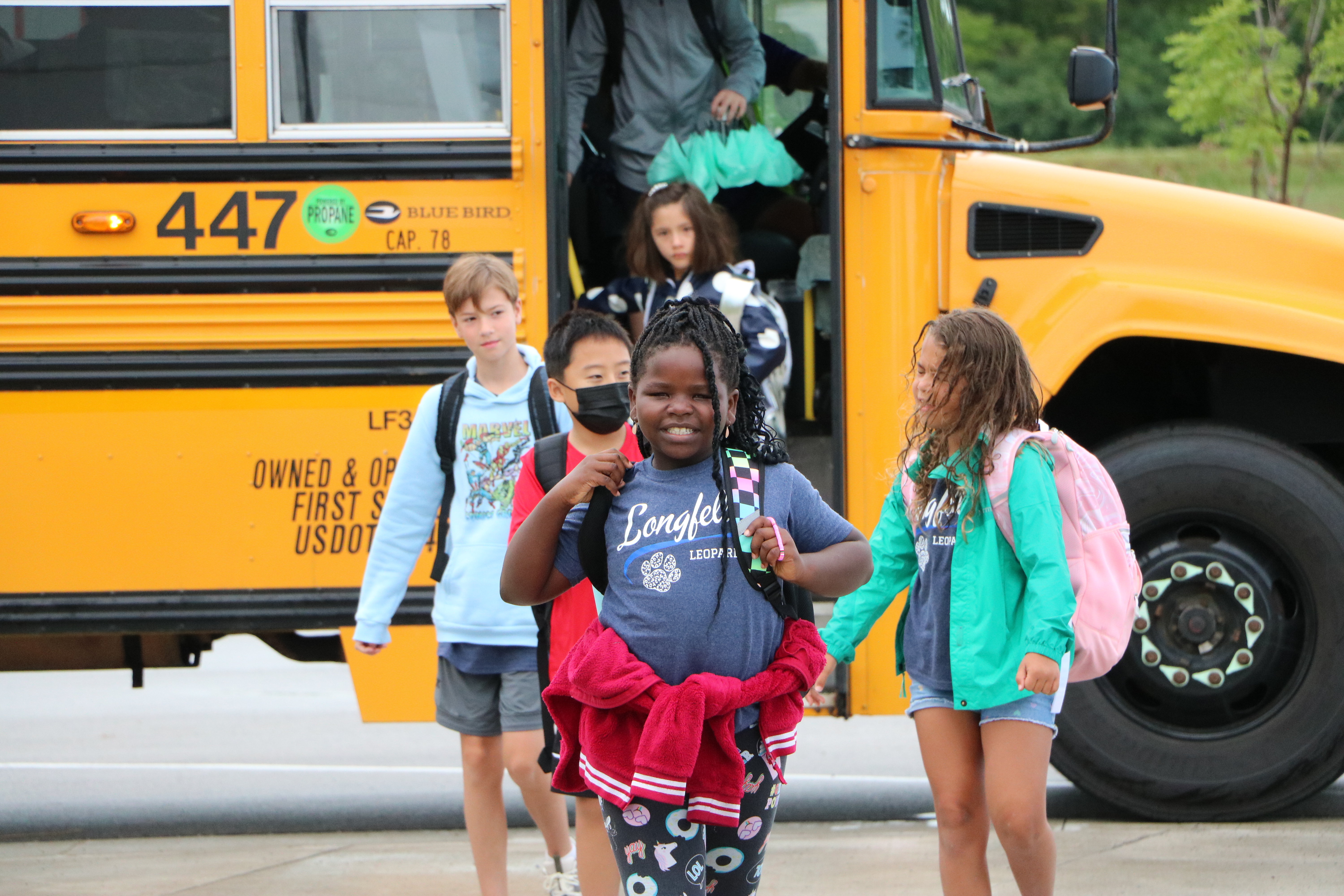 Student getting off of the bus at Longfellow Elementary on the First Day of School