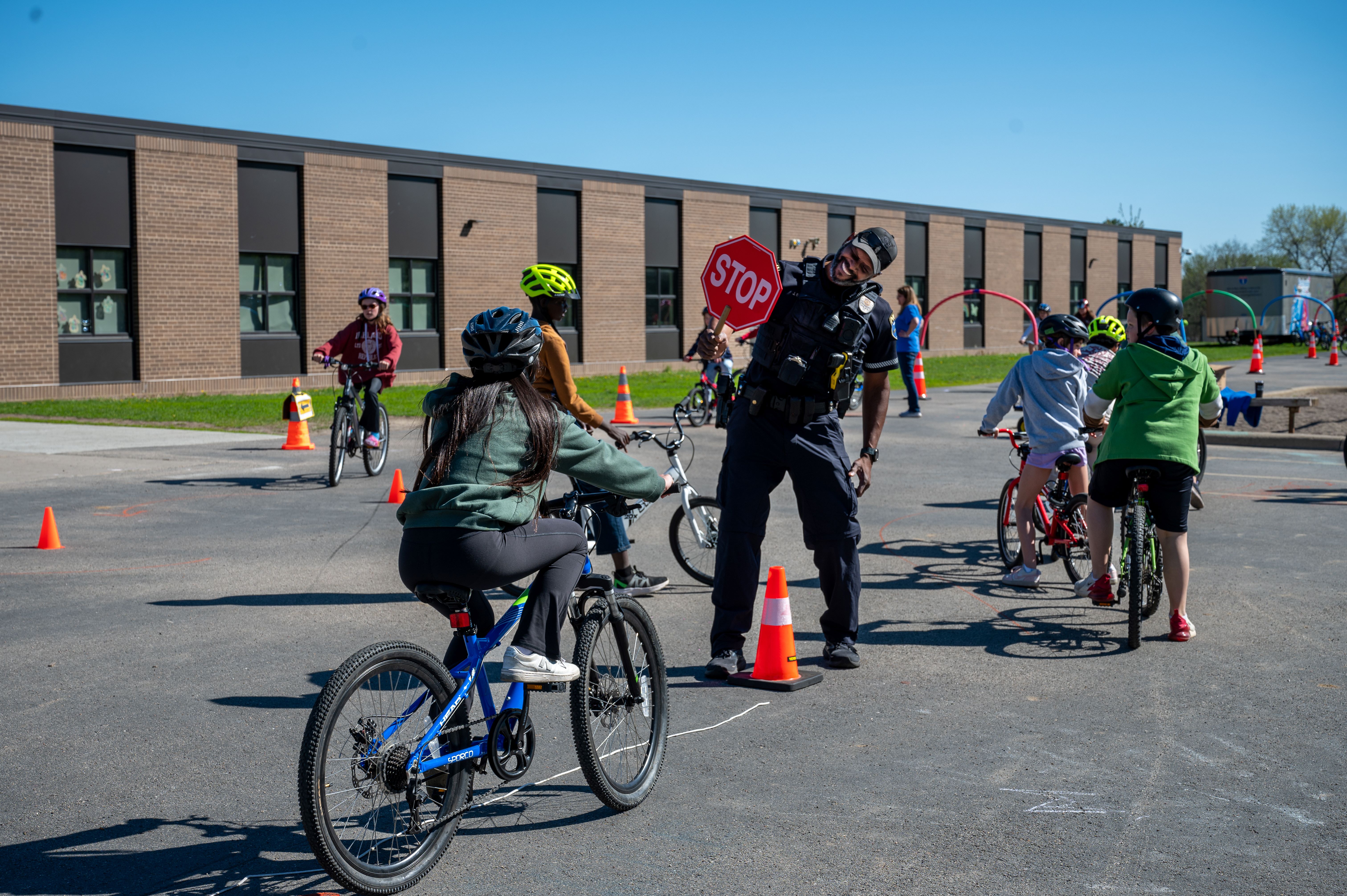 students on bikes practicing safety stops with police