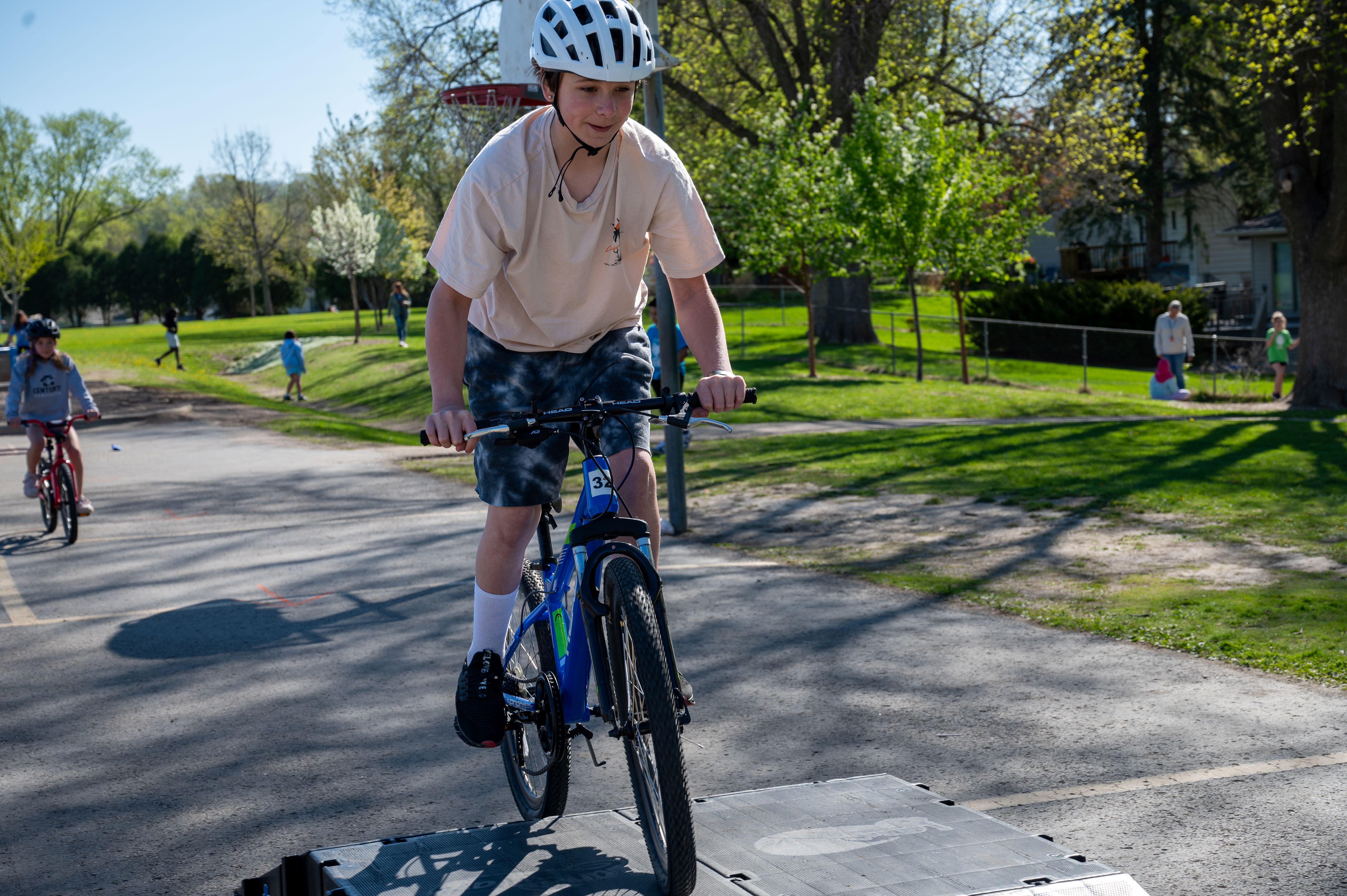 student on bike going over ramp