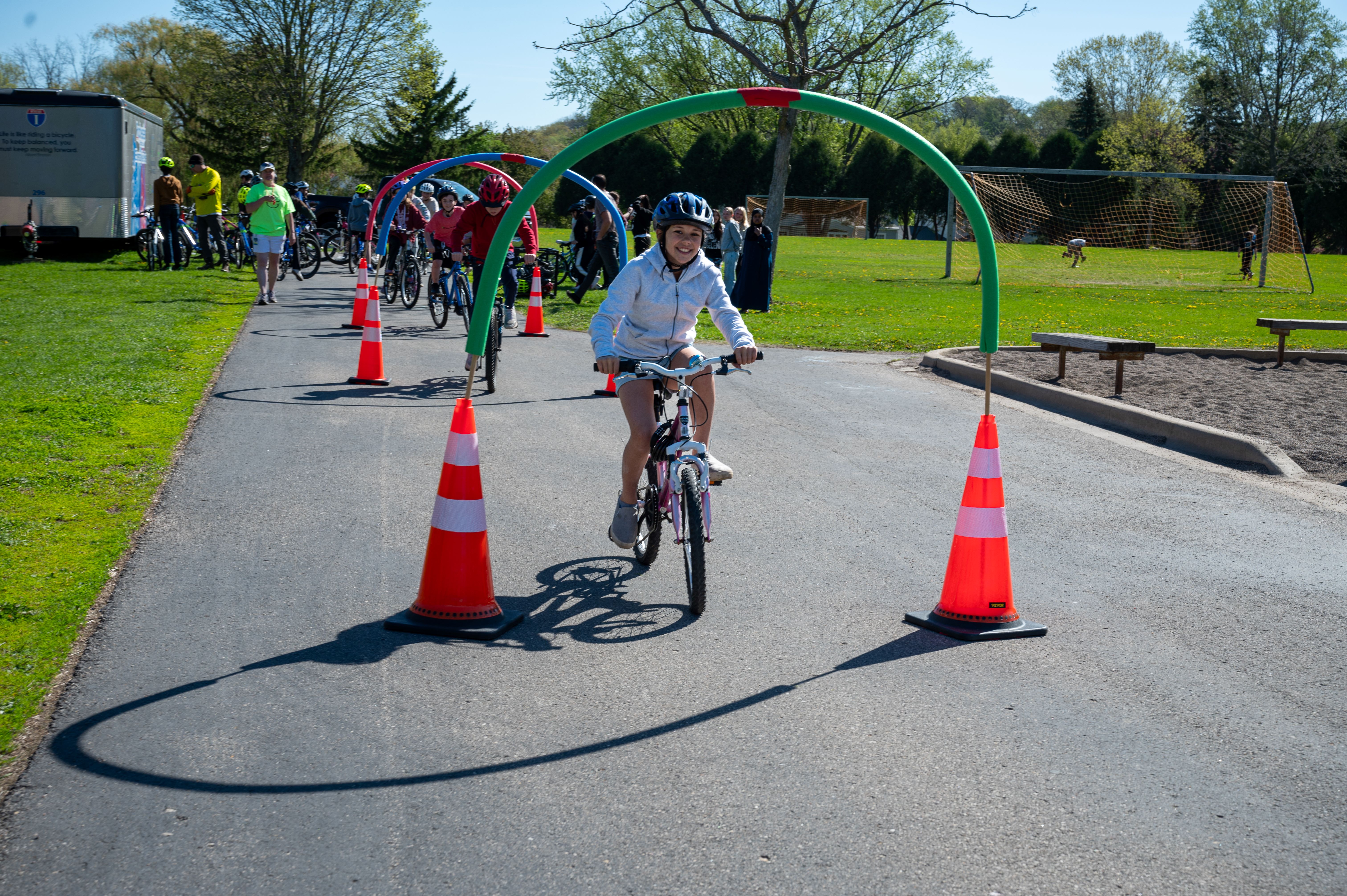 girl on bike going through hoops