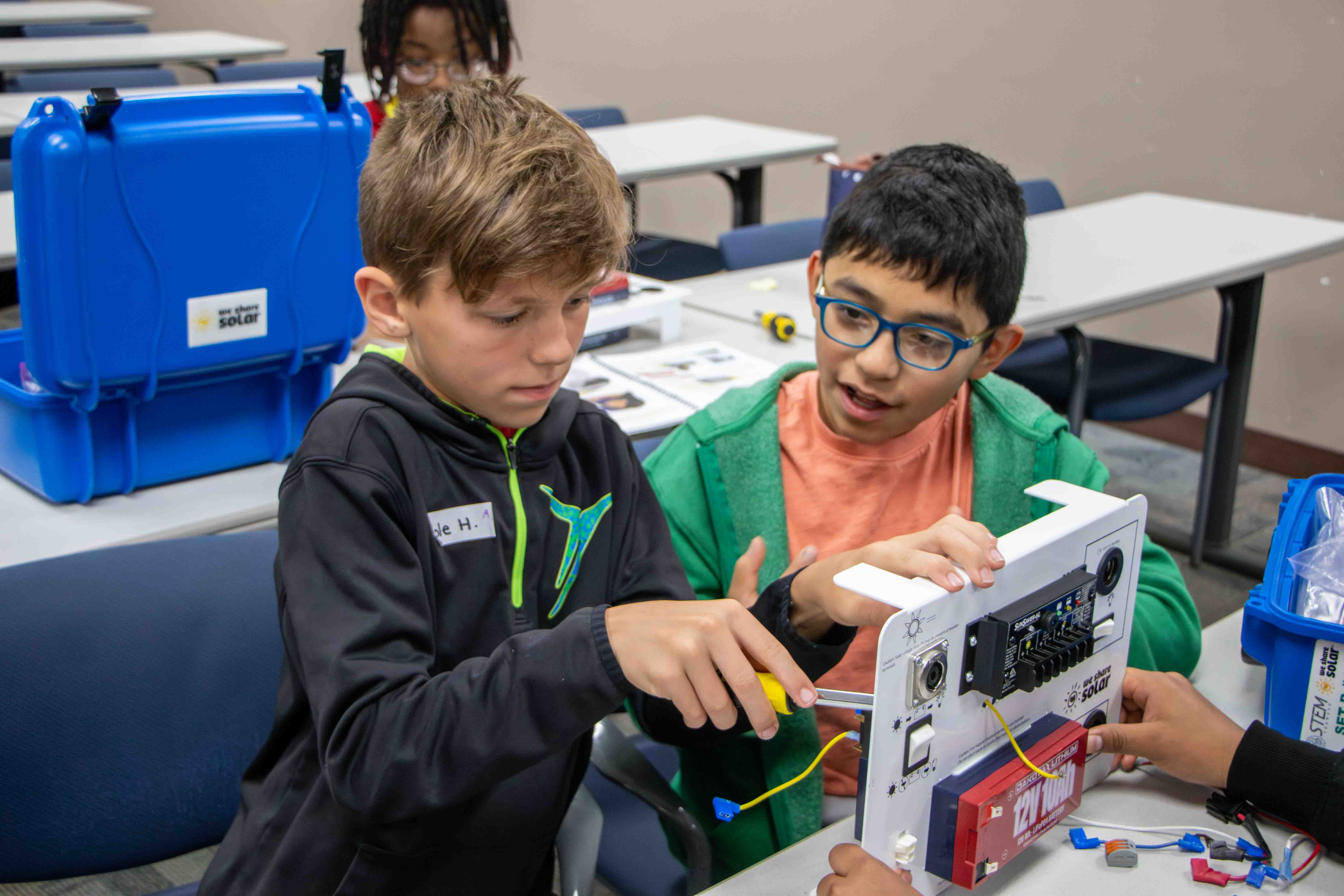 Two middle school boys working on a STEM project