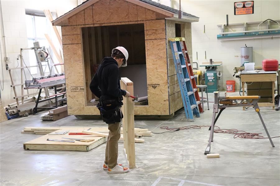 student builds a house