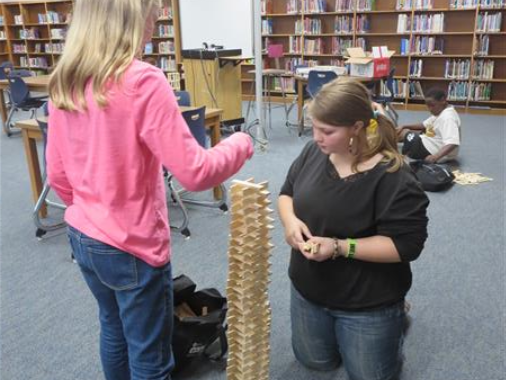 Two students working on their own tower.