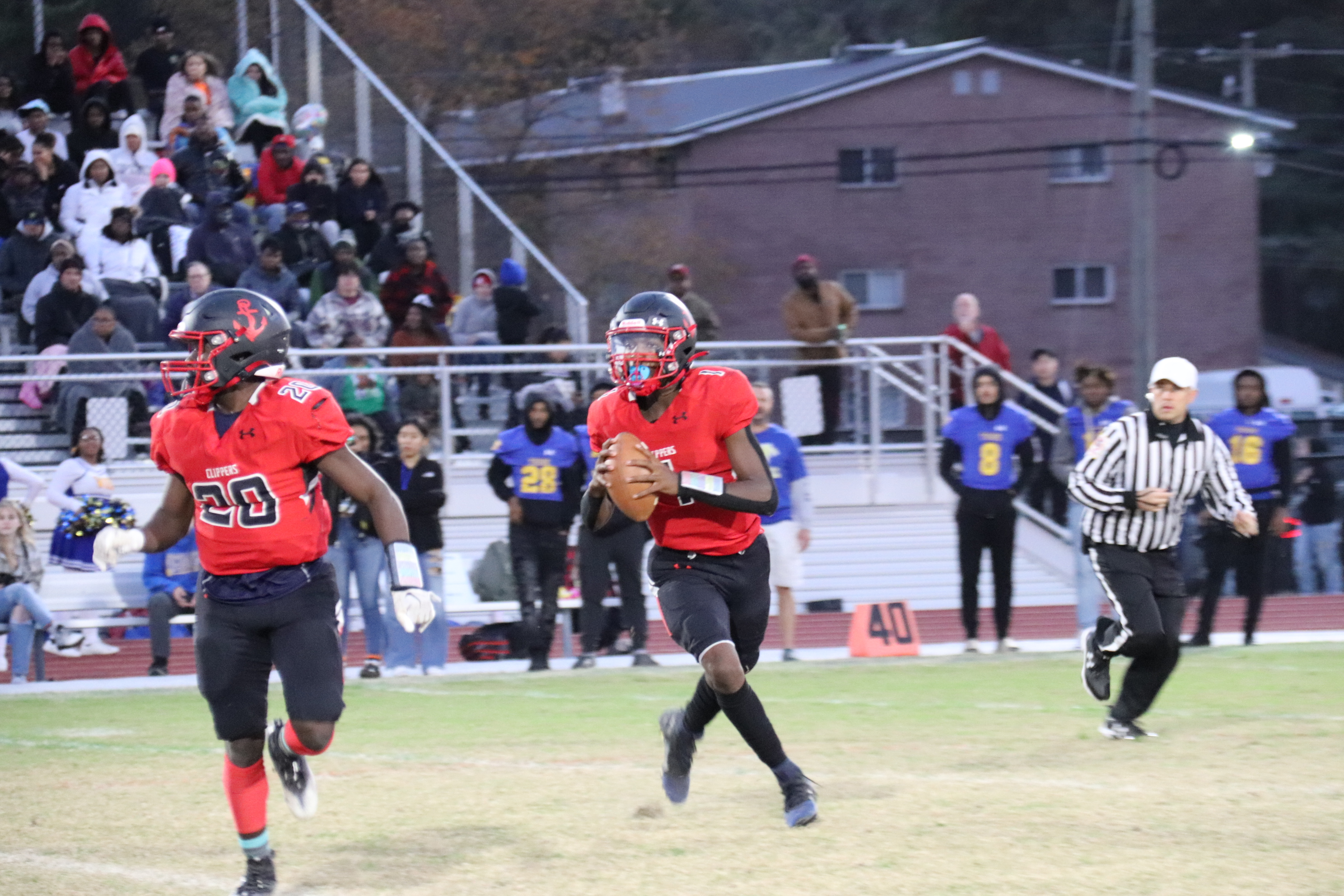 quarterback rolls out looking to pass the football 