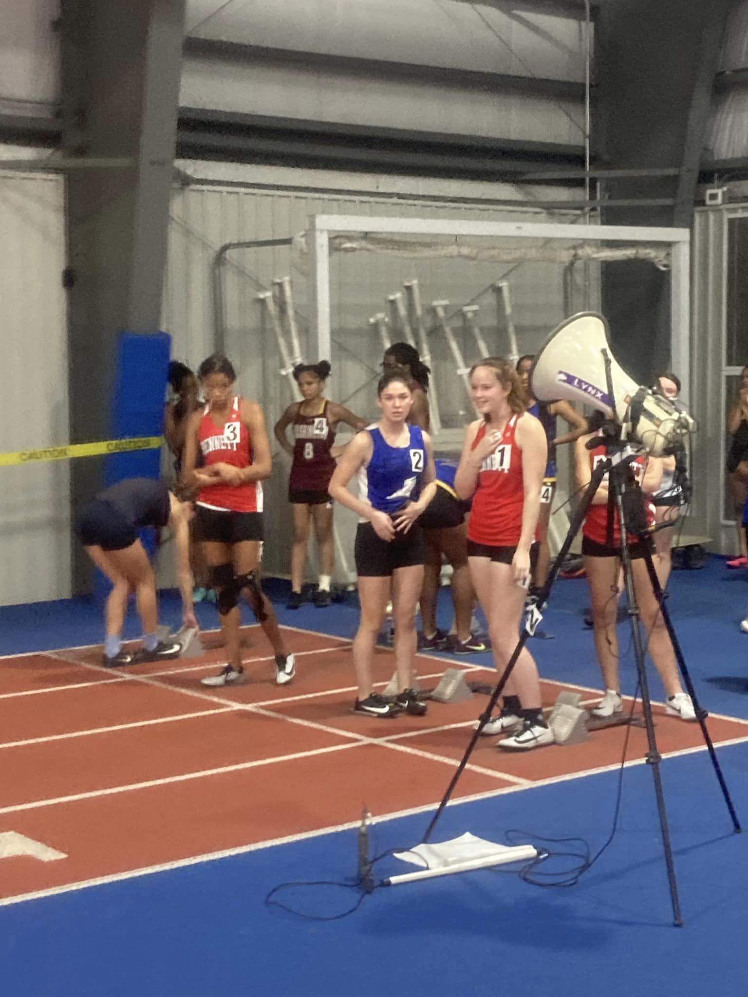 lining up to run at indoor track meet