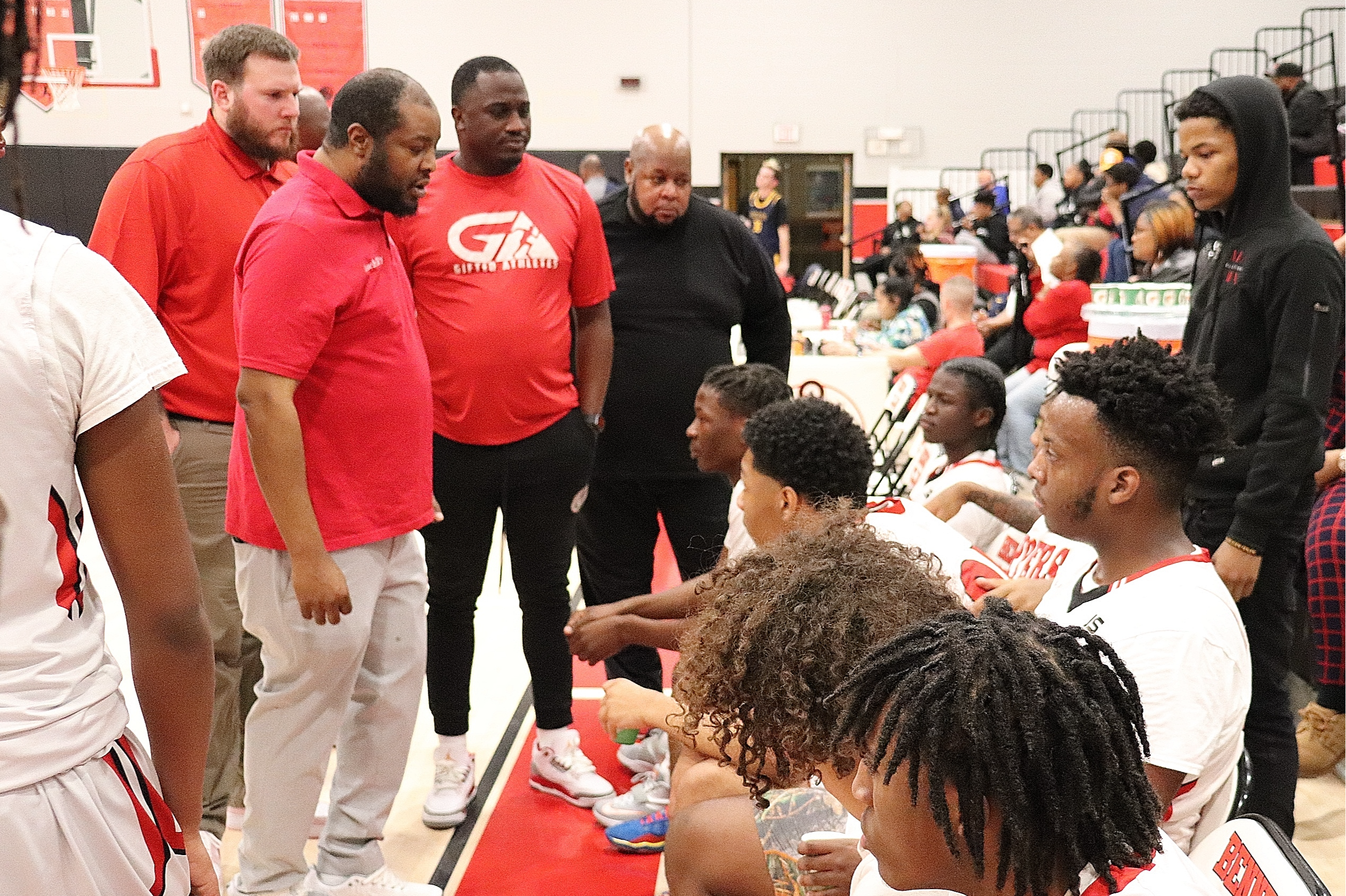 Coach talks to players in the huddle