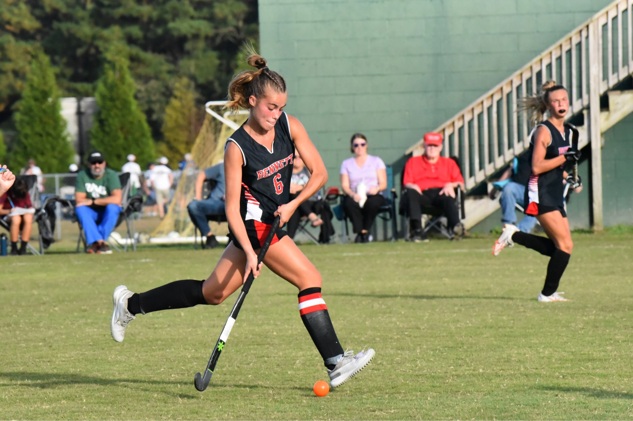 Image of Bennett High field hockey team pushing the ball up the field vs Parkside