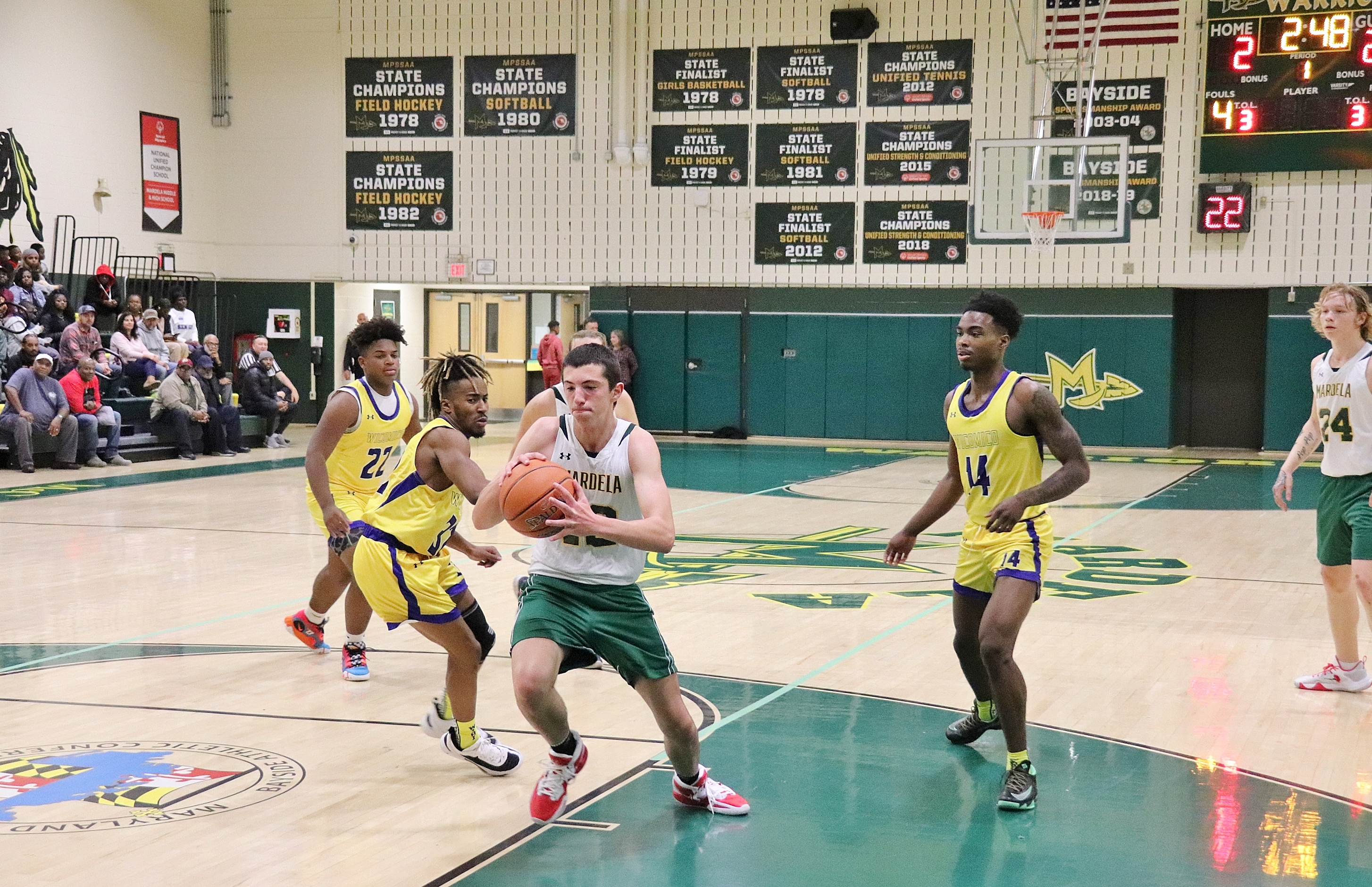 boys basketball player driving to the basket to shoot the ball