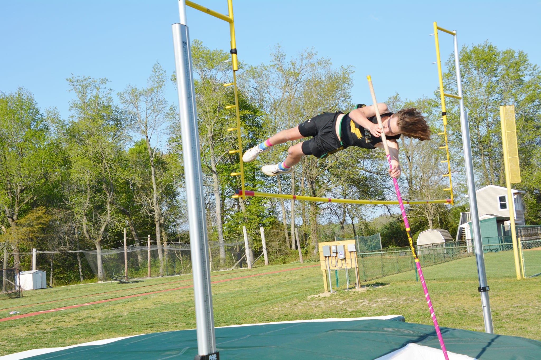 high school boy attempting the pole vault