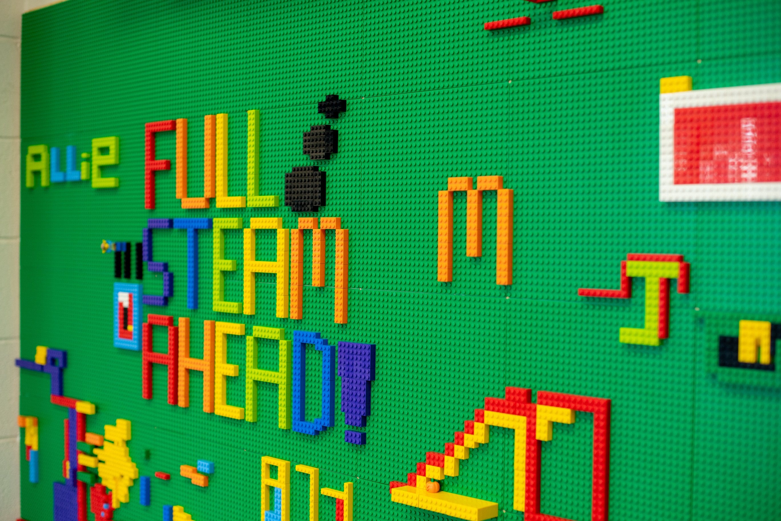 "Full Steam Ahead" written in colored legos