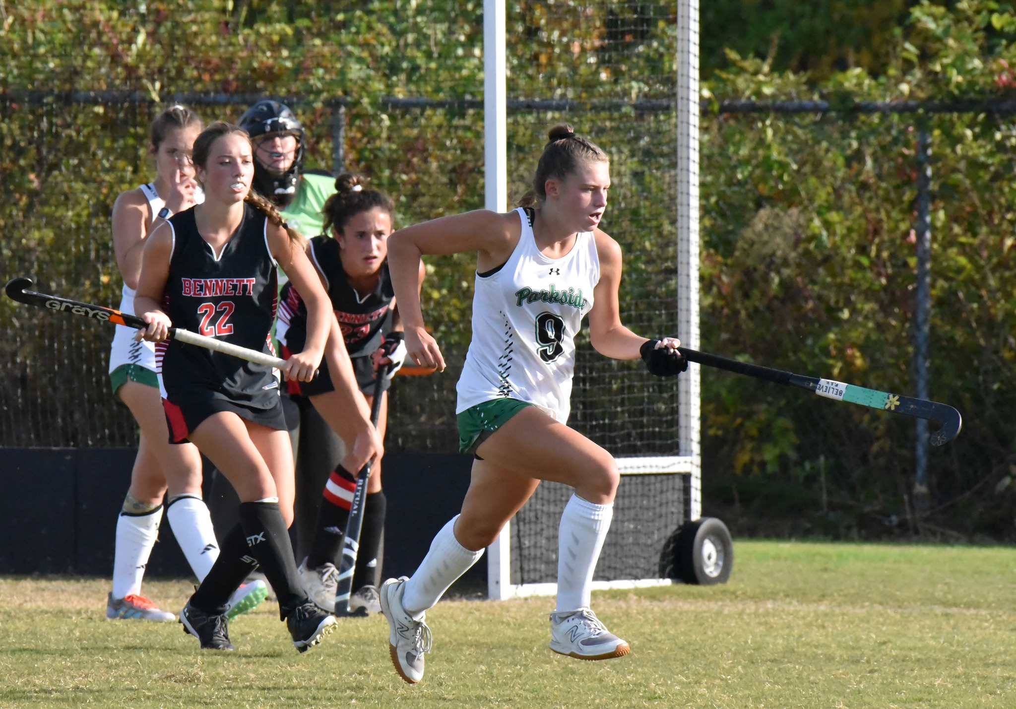 Image of Parkside High field hockey player running to the ball