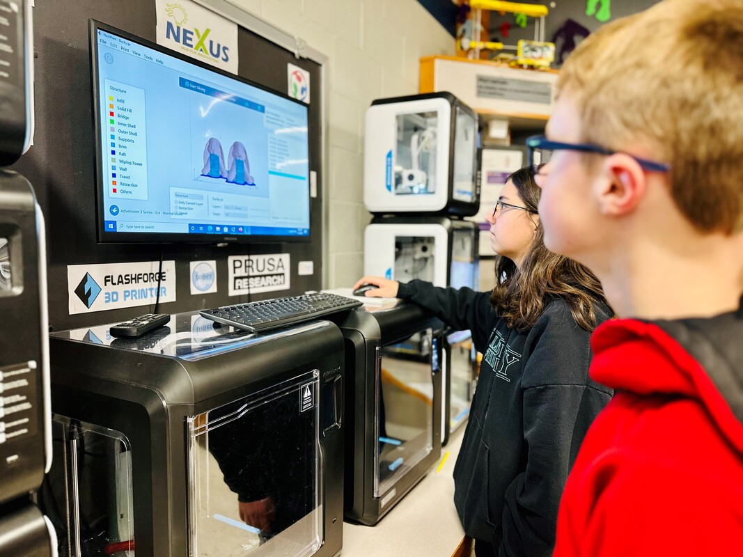 Image of two students working on Nexus