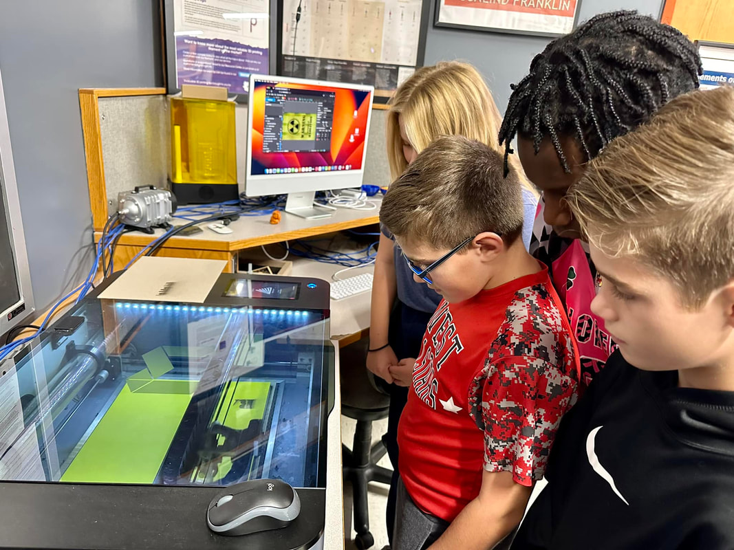 Image of students observing 3D printing