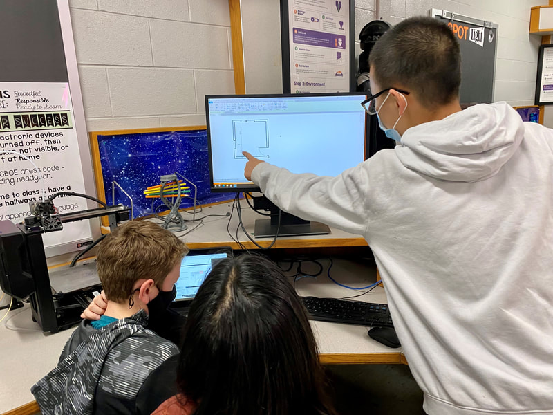 Image of student pointing to the computer screen