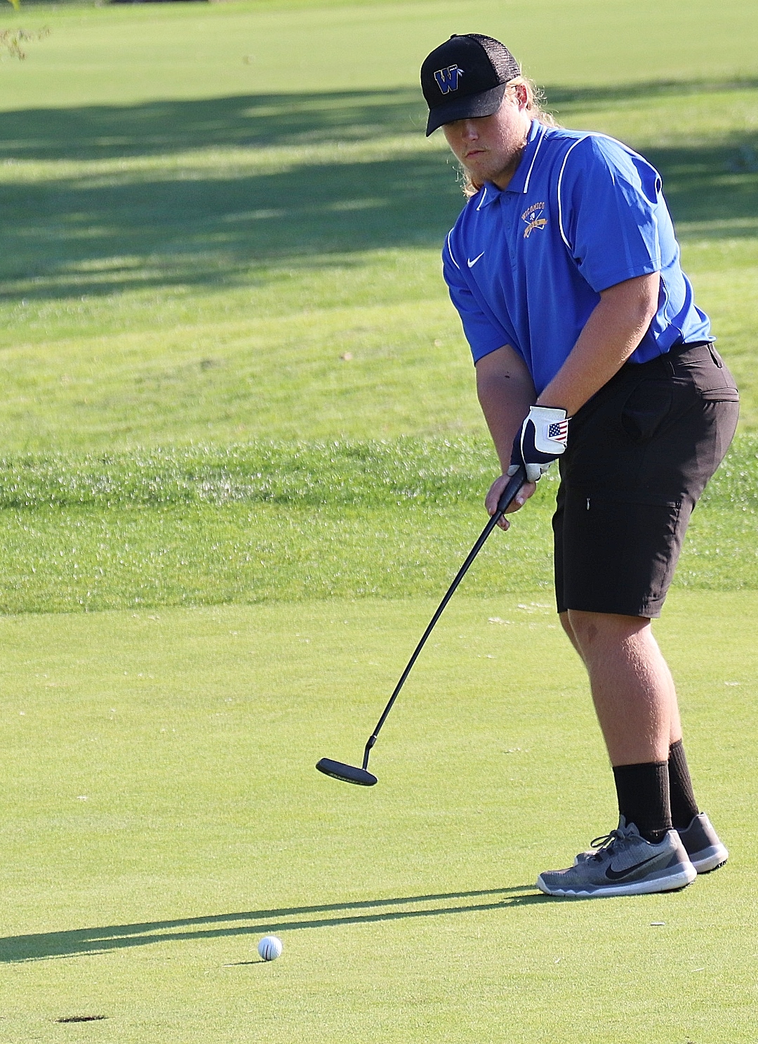 golfer hitting a chip shot