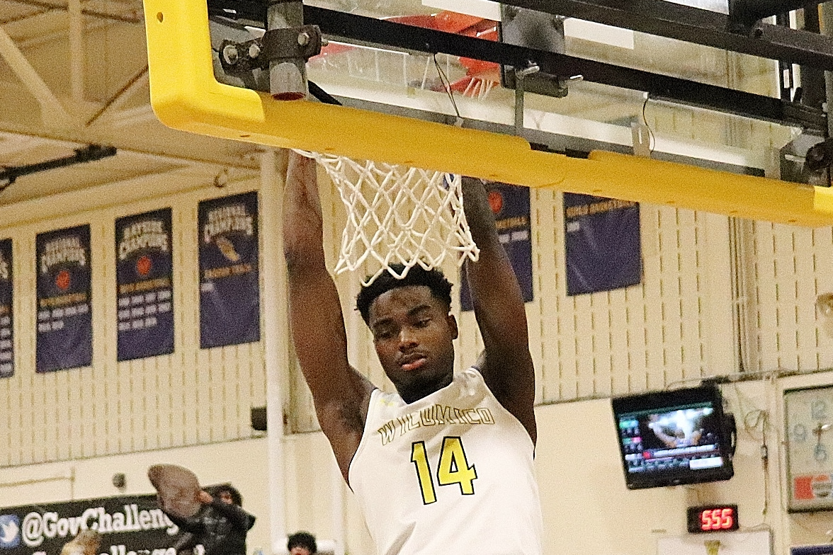 player with a two handed slam dunk in basketball