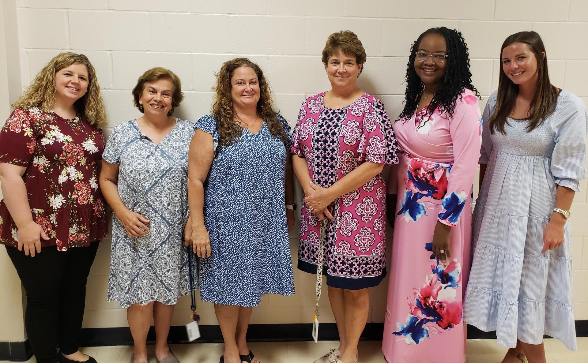 Ms. Hendricks, Ms. Chamblee, Ms. Lamm, Ms. Parrish, Ms. Bland, Ms. Reavis standing in a row in the hallway