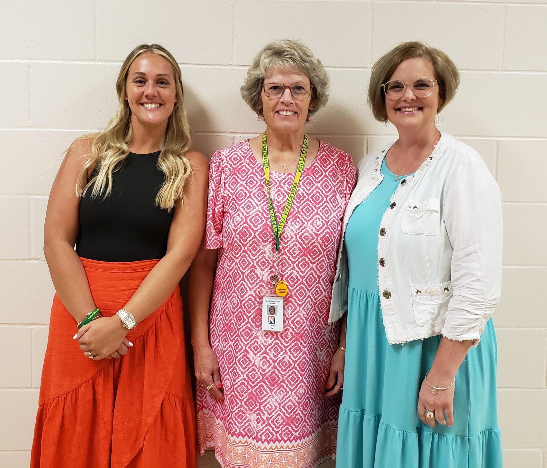 Ms. Leithead, Ms. Ray, Ms. Joyner standing for a group photo in the hallway