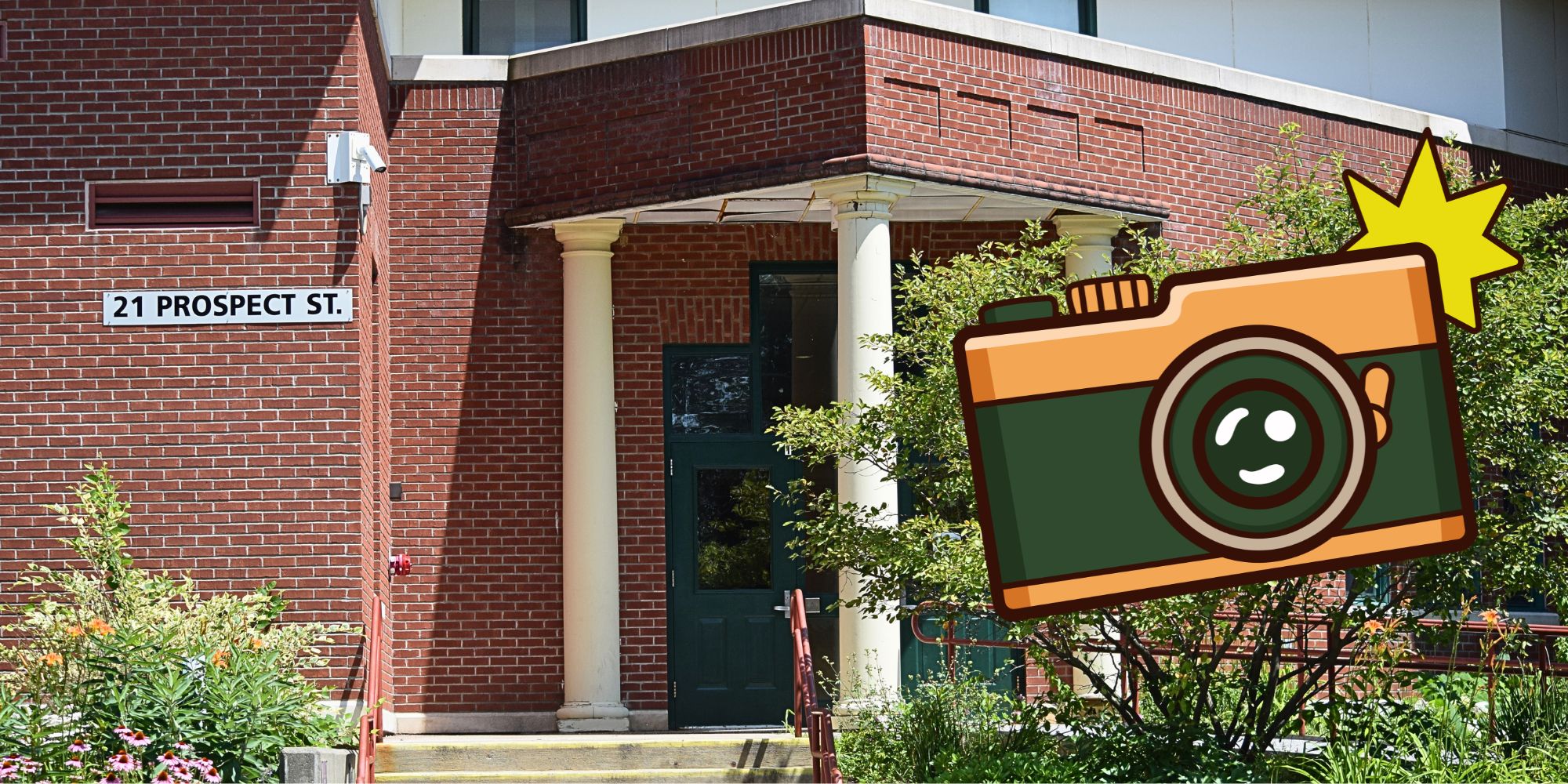 A red-brick building with a sign reading "21 Prospect St." has a camera graphic with a star and a smiley face.