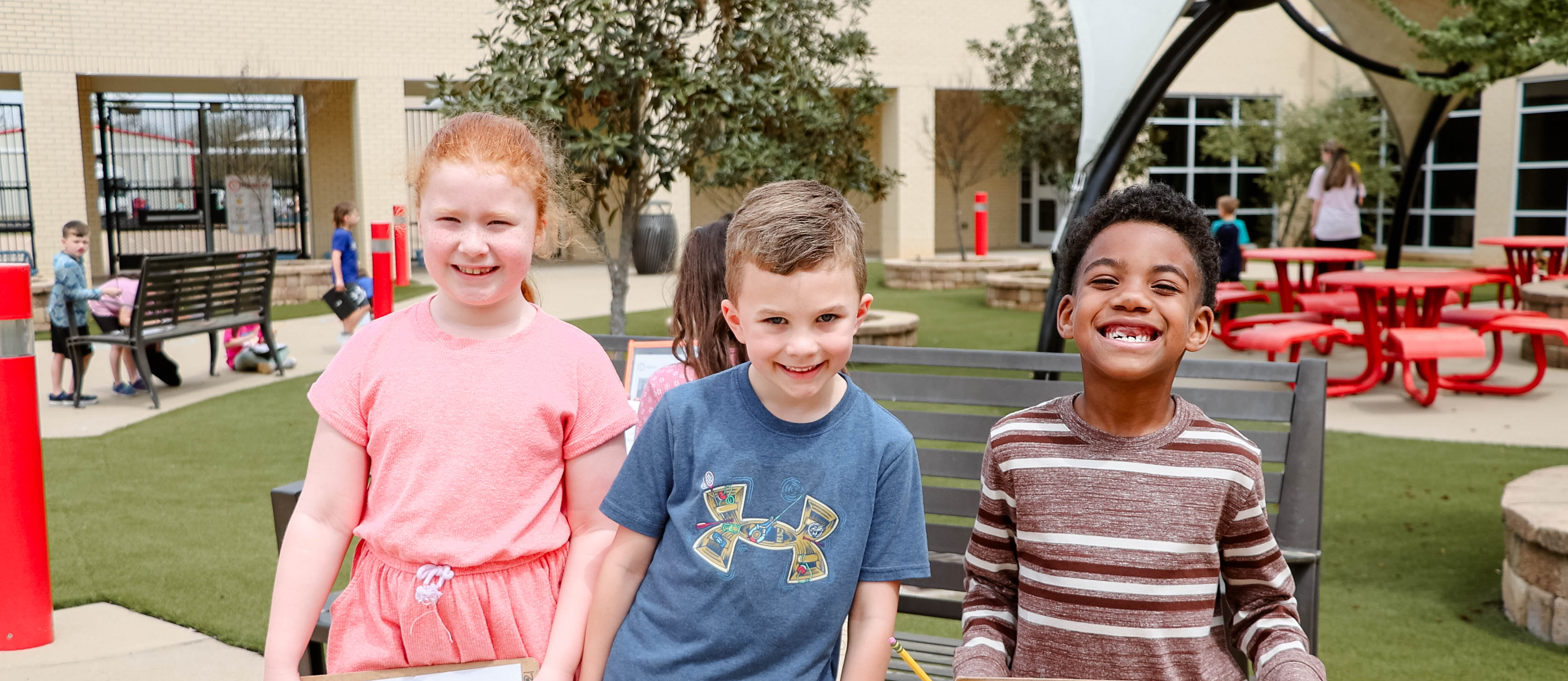 students smiling together in courtyard