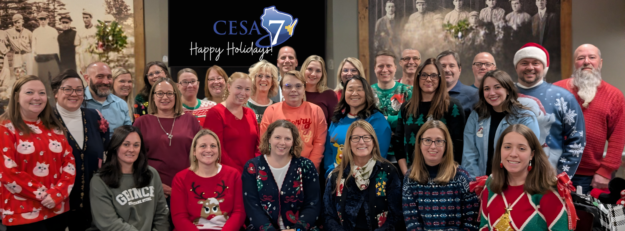 CESA 7 Group sitting and standing together with Happy Holidays CESA 7