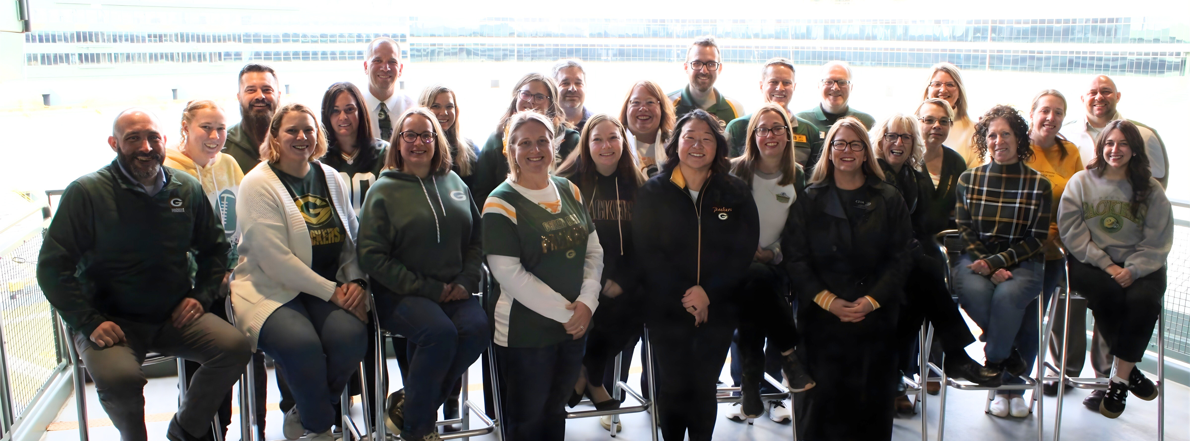 Large group of CESA 7 standing side by side on a balcony at Lambeau Field
